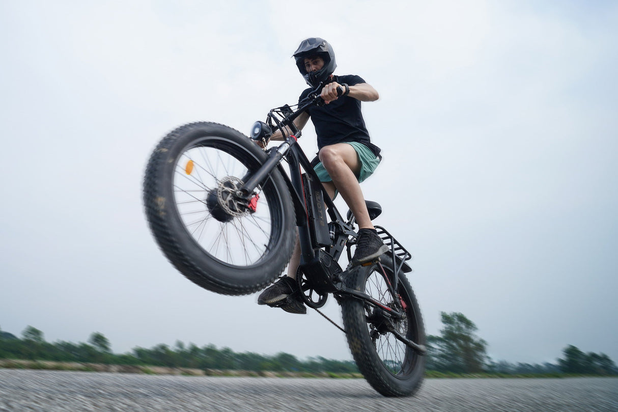 Rider on DUOTTS S26 adult electric bike, showcasing offroad capabilities with pedal assist and full suspension in action.